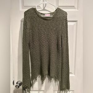 Army green light sweater with fringe styling on sleeves and bottoms.